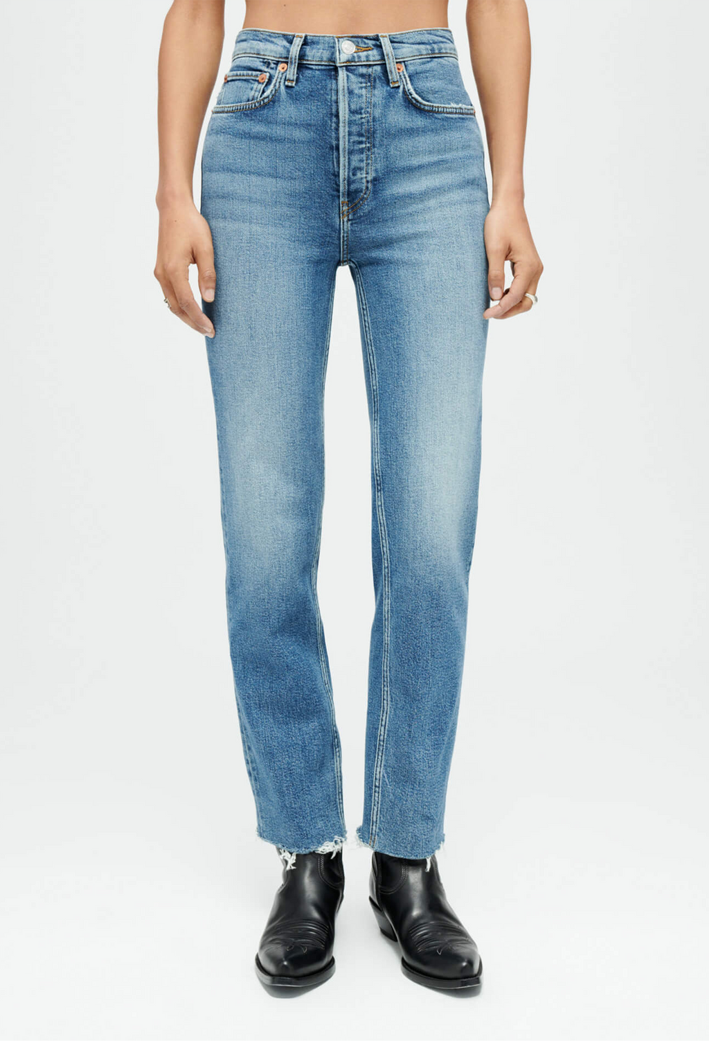 Person wearing light blue jeans on a white background