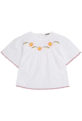 White blouse with floral embroidery on a white background