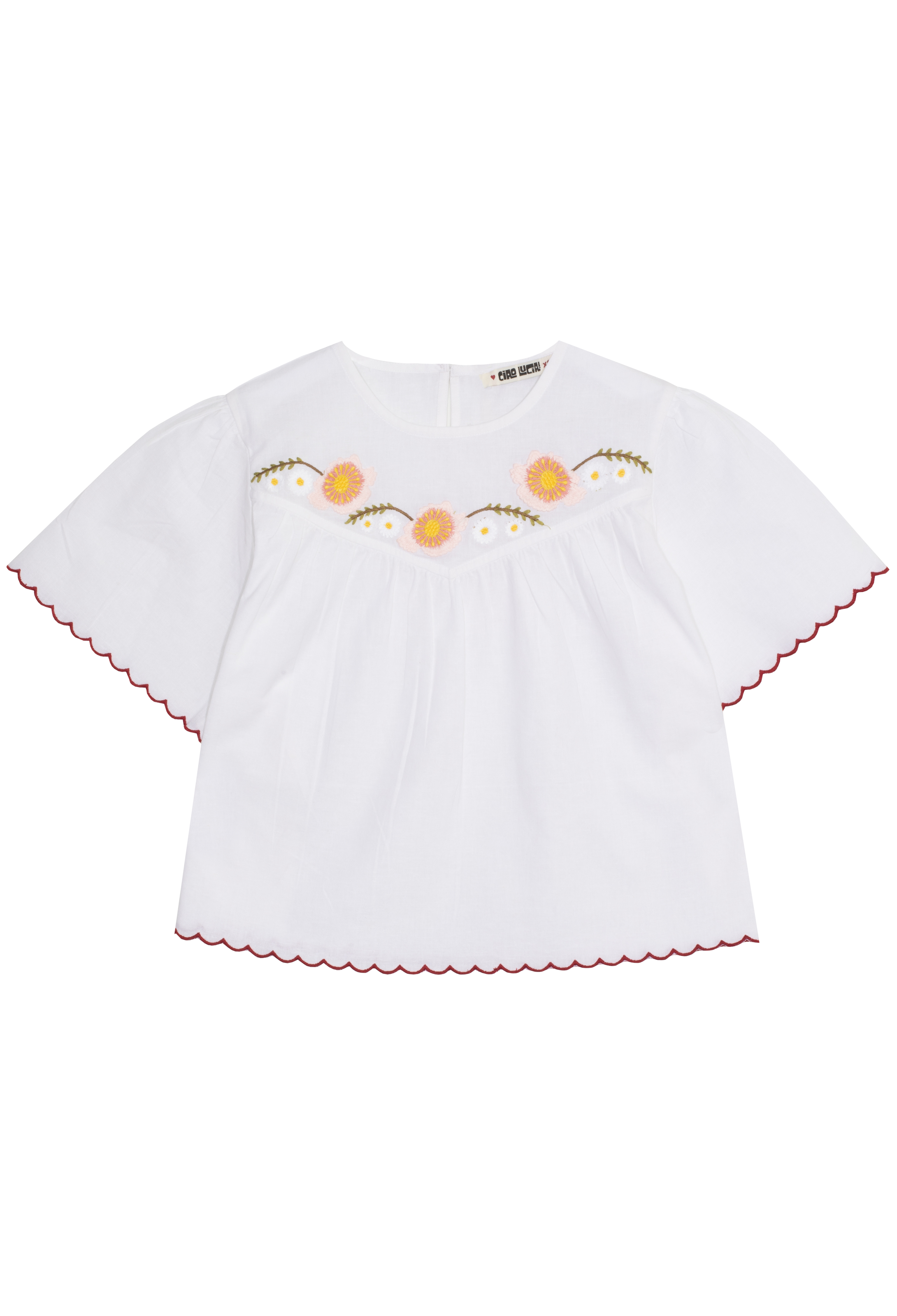 White blouse with floral embroidery on a white background