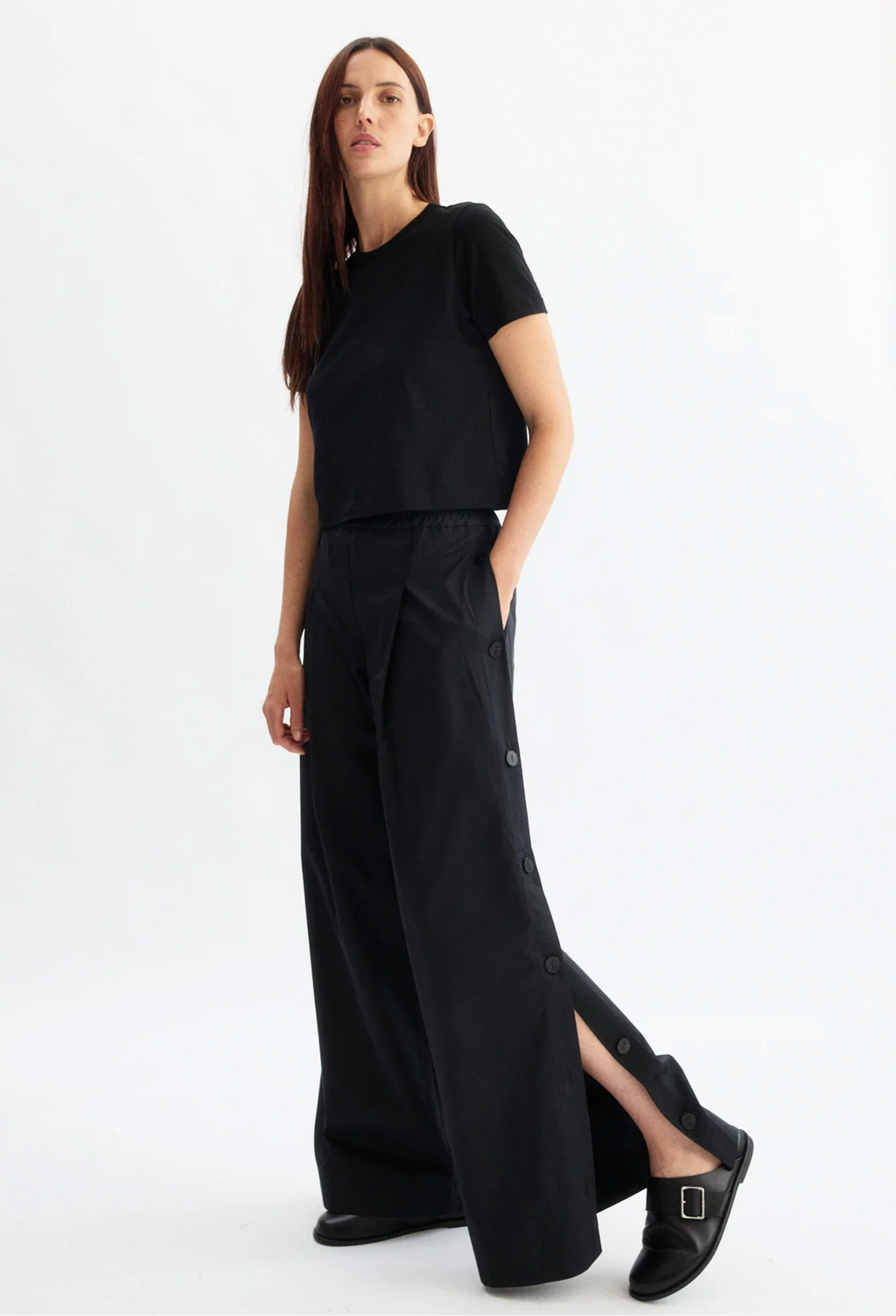 Woman wearing a black outfit on a white background