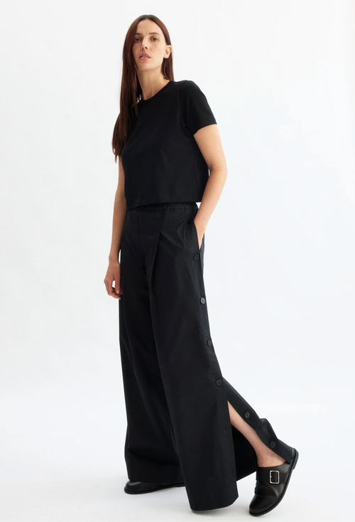Woman wearing a black outfit on a white background