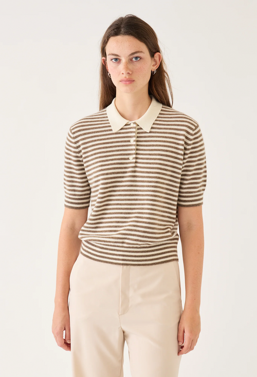 Woman wearing a striped shirt with a white collar against a plain background