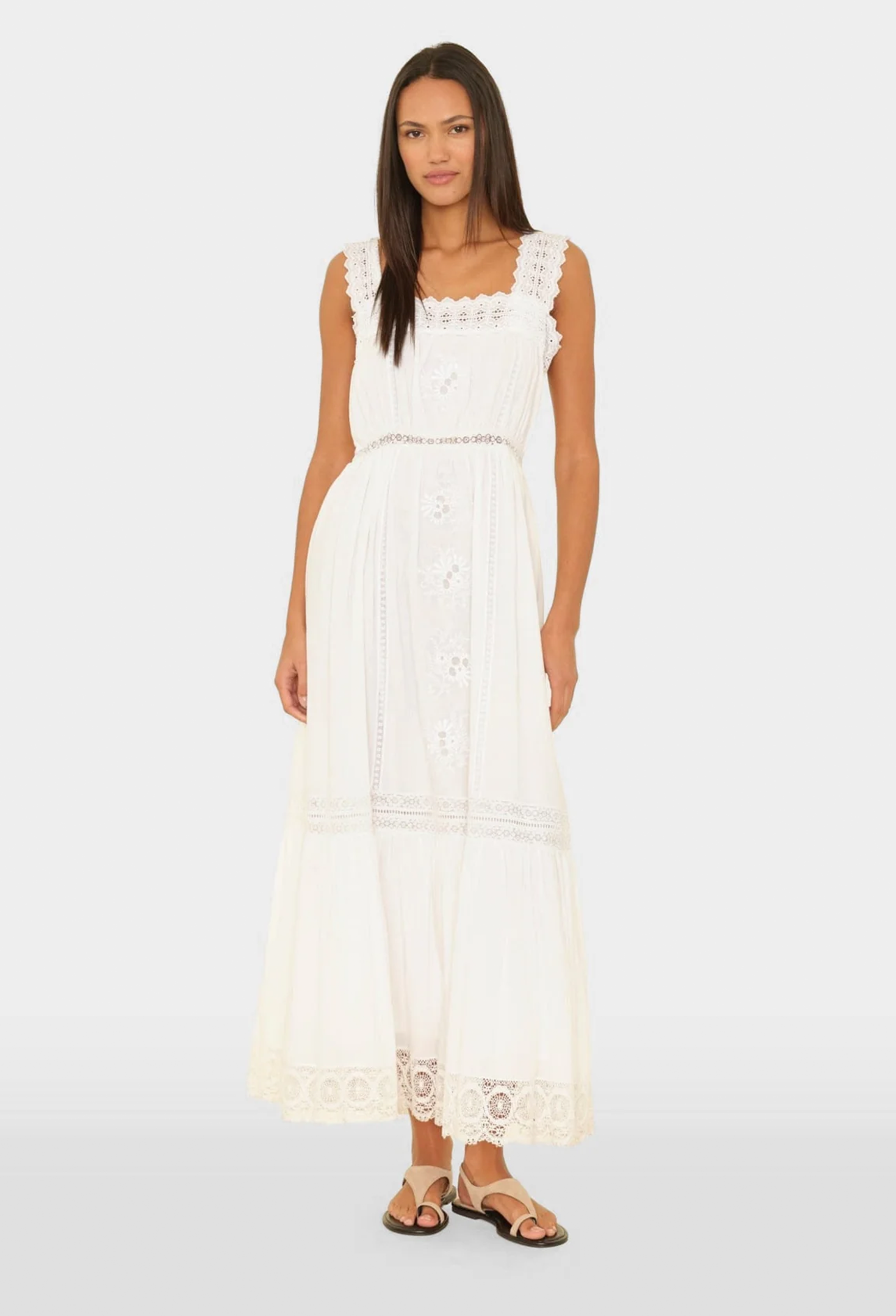 Woman wearing a white lace dress on a white background