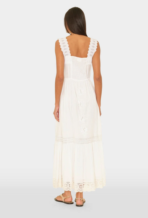 Woman wearing a white lace dress on a white background