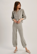 Woman wearing a gray outfit on a white background