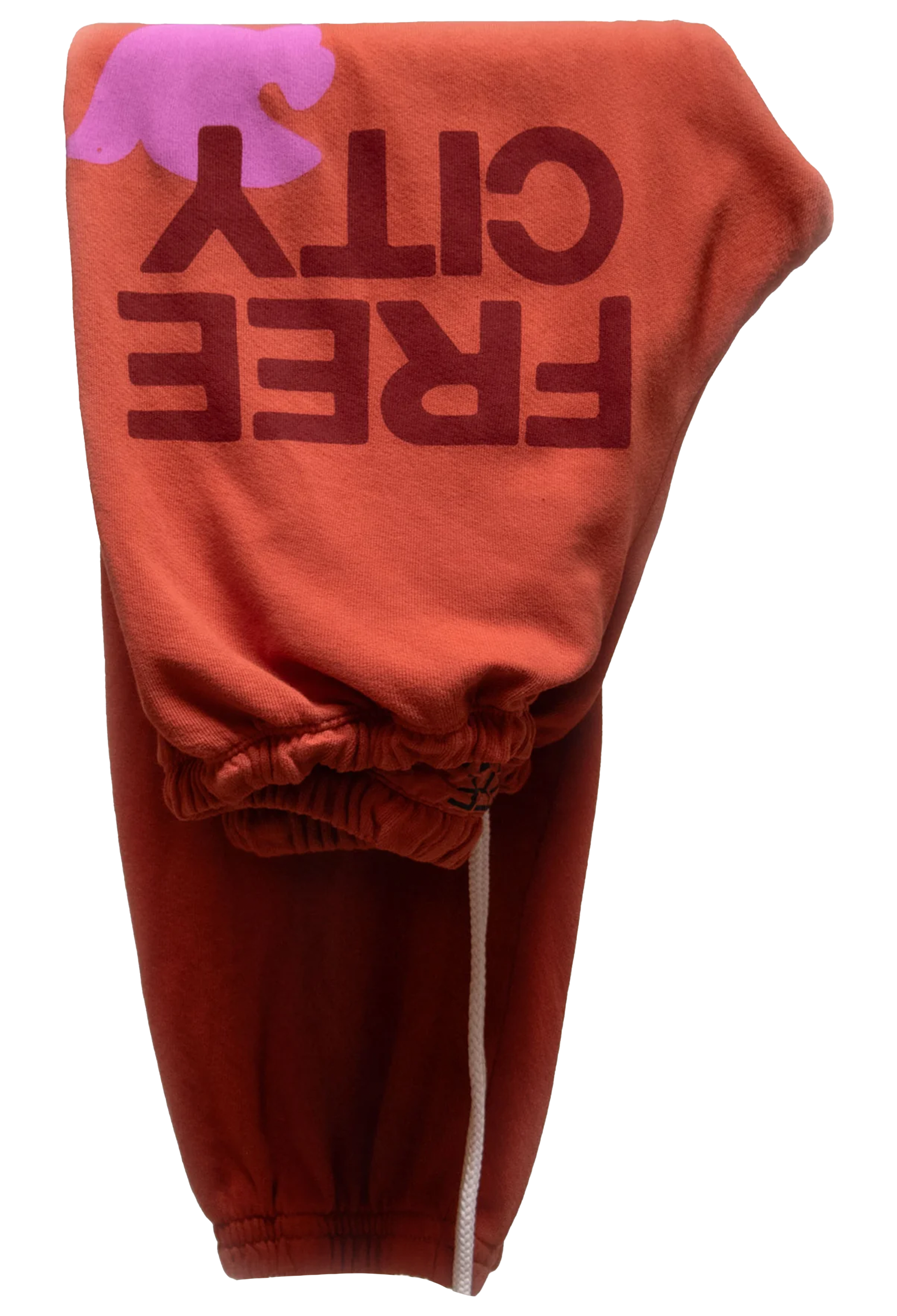 Orange sweatpants with 'FREE CITY' text on a white background