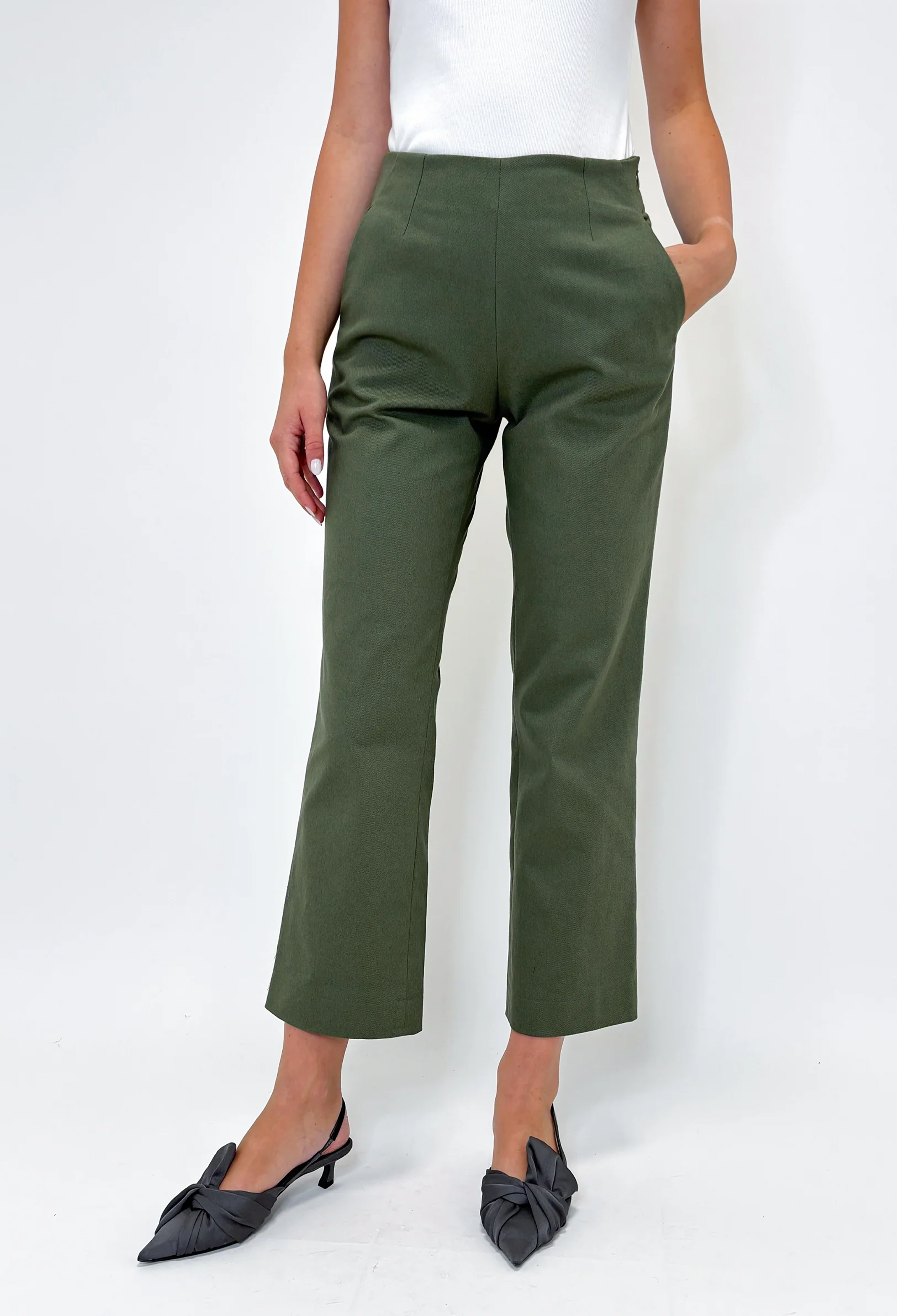 Person wearing green pants on a white background