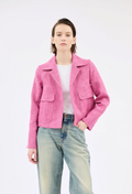 Person wearing a pink jacket and blue jeans on a white background