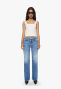 Woman wearing a white top and blue jeans on a white background