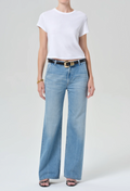 a model wearing light blue jeans and white tee on a white background