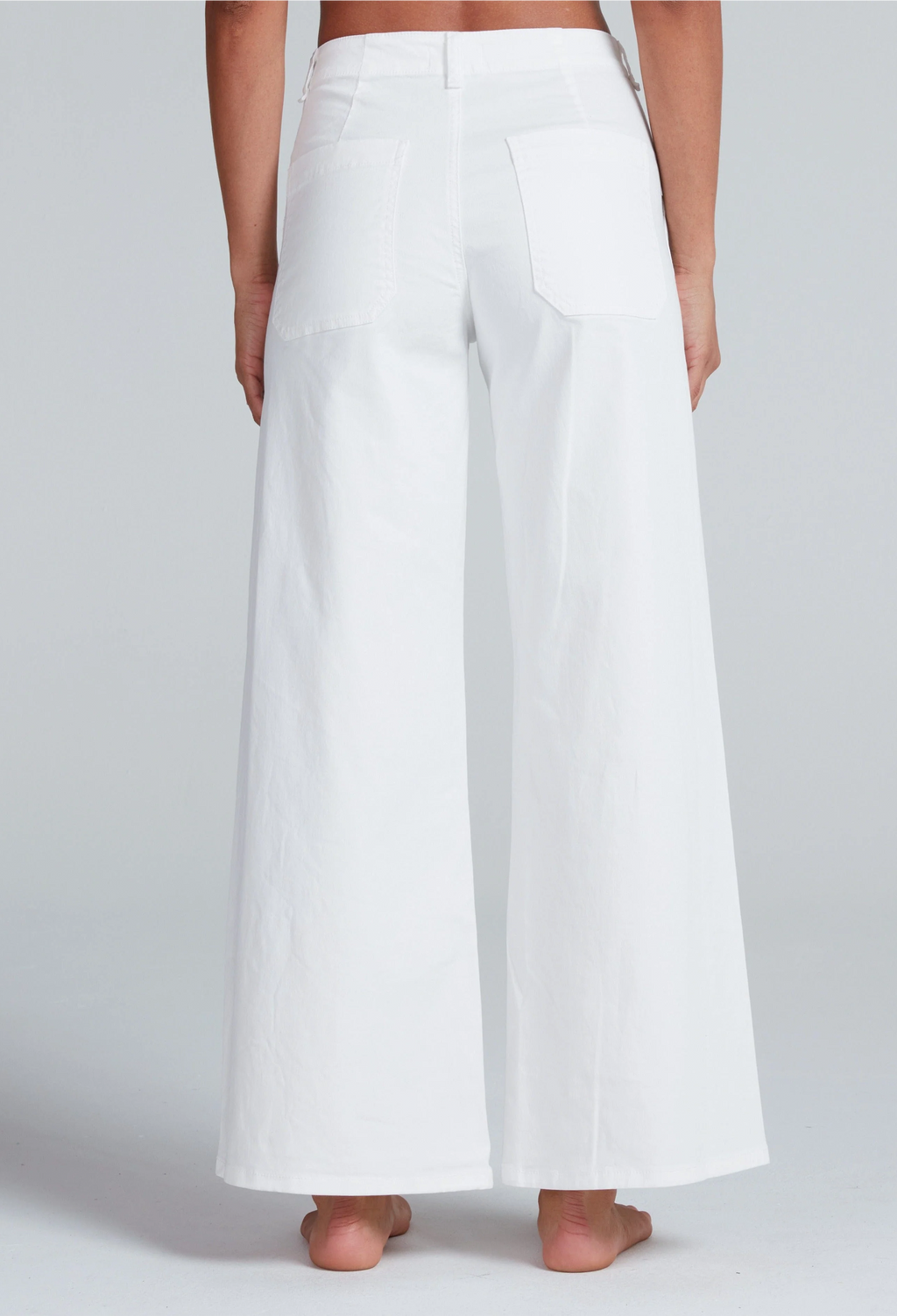 White wide-leg pants worn by a person on a plain background