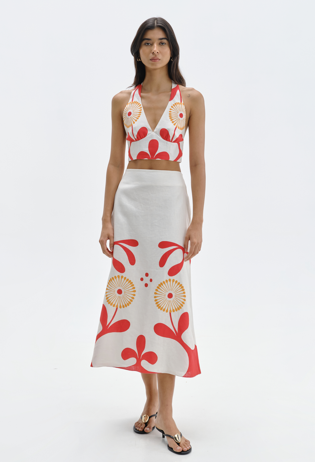Woman wearing a floral top and skirt set on a white background