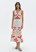 Woman wearing a floral top and skirt set on a white background