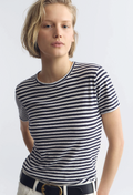 Person wearing a blue and white striped shirt on a plain background