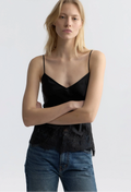 model wearing a black silk tank with lace hem on a white background