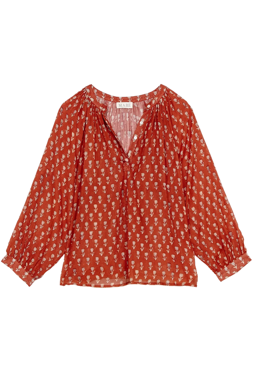 Red patterned blouse on a white background