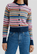 Multicolored striped sweater with buttons worn by a person, paired with blue jeans on a plain background.