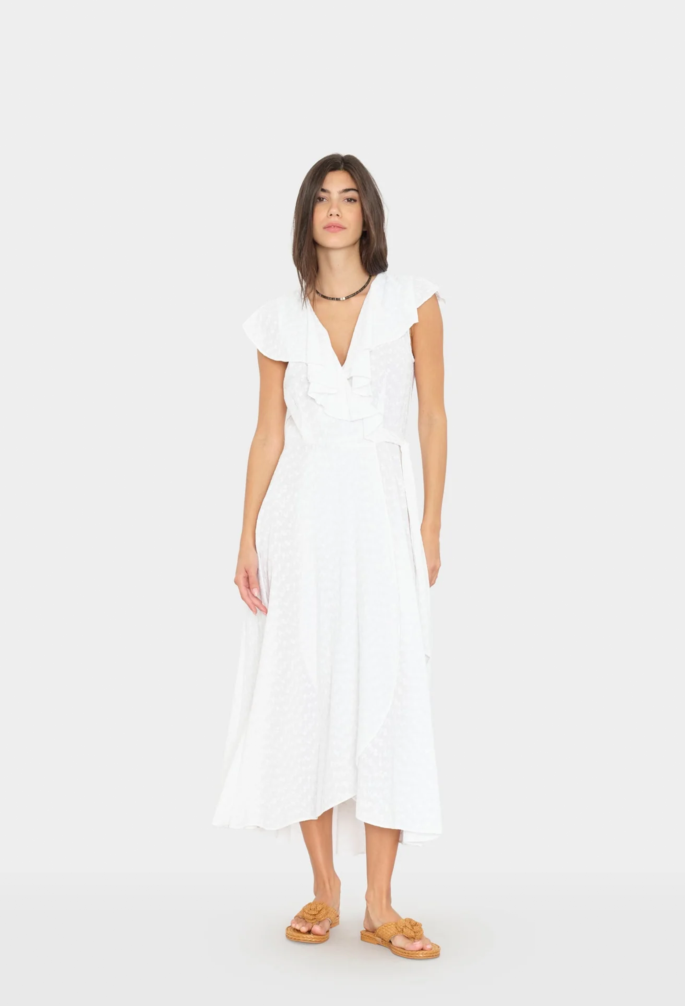 Woman wearing a white dress on a white background