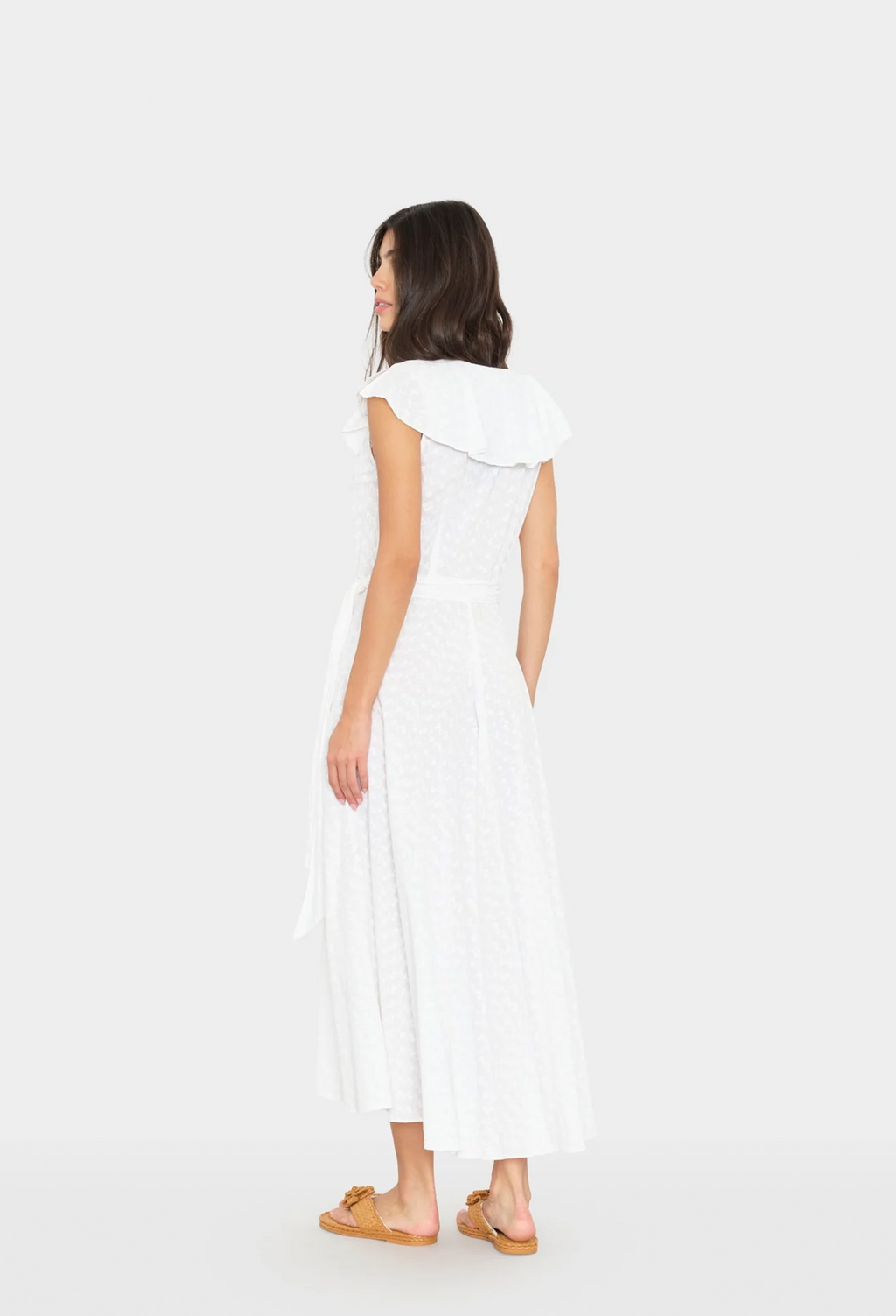 Woman wearing a white dress on a white background