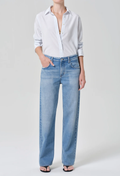 Person wearing a light blue shirt and jeans on a white background