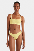 Woman wearing a yellow bikini set on a white background