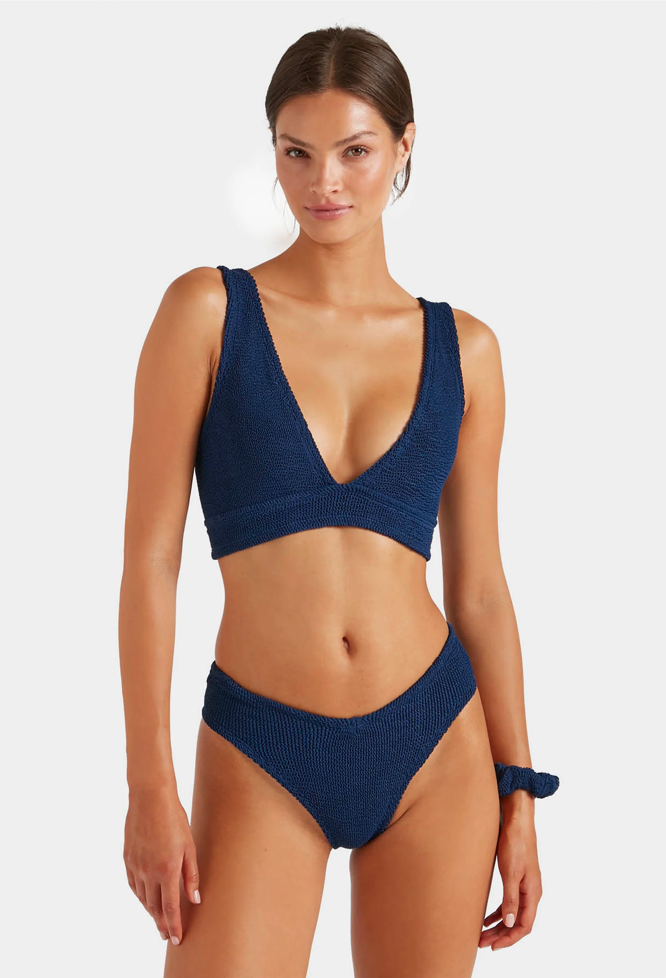 Woman wearing a blue bikini set on a white background