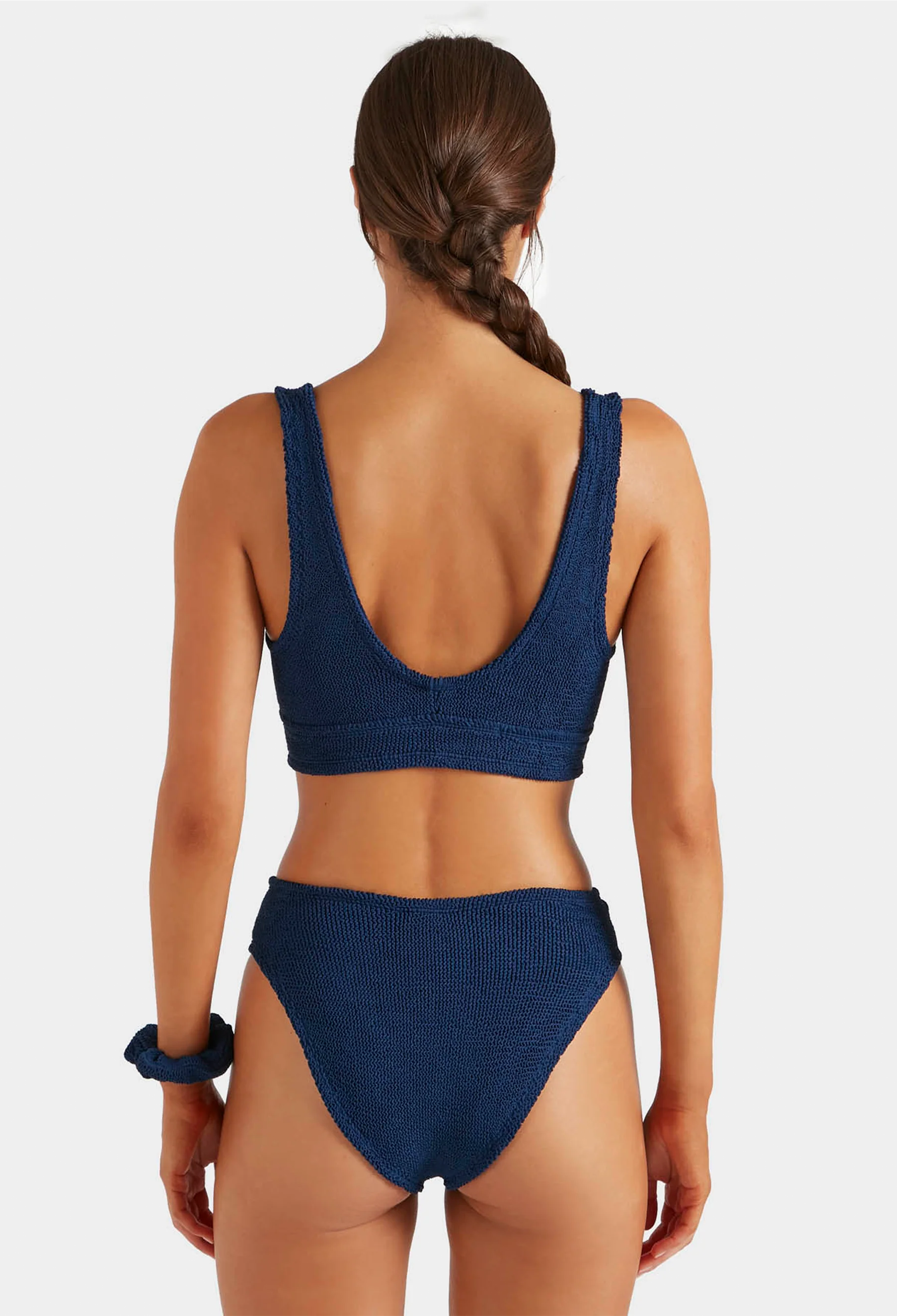 Woman wearing a blue bikini set on a white background