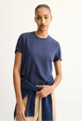 Person wearing a blue t-shirt with a white background