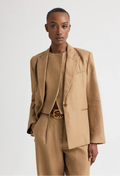 Person wearing a beige suit with a white background