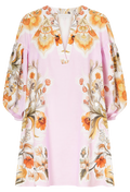 Floral patterned blouse with long sleeves on a light pink background