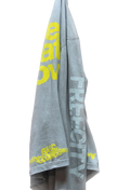 Gray tee with yellow text on a white background