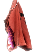 Red shorts with black and white designs on a white background
