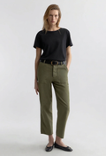model wearing a black tee and olive green pants on a white background