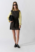 model wearing a sleeveless mini black dress on a white background