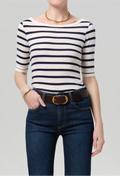 model wearing jeans and a blue and white striped boatneck tee