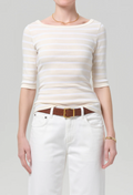 model wearing jeans and a off white and white striped boatneck tee