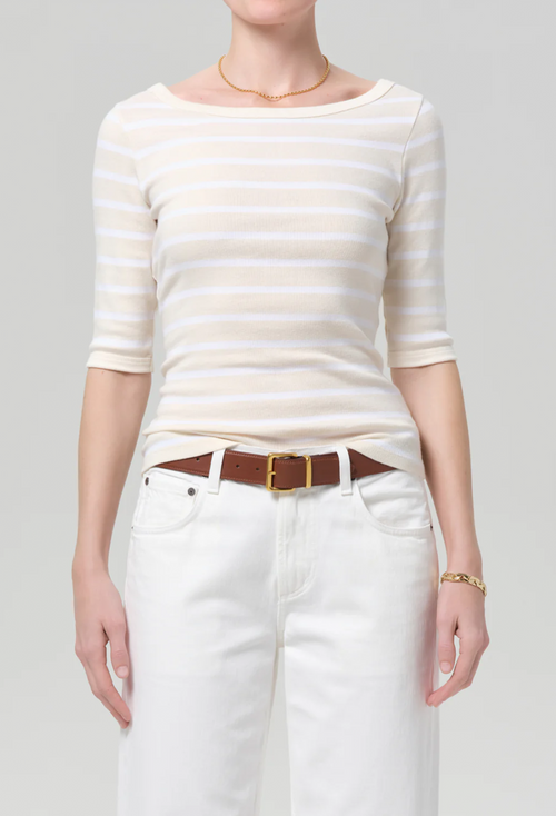 model wearing jeans and a off white and white striped boatneck tee