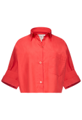 boxy cropped red button up shirt on a white background