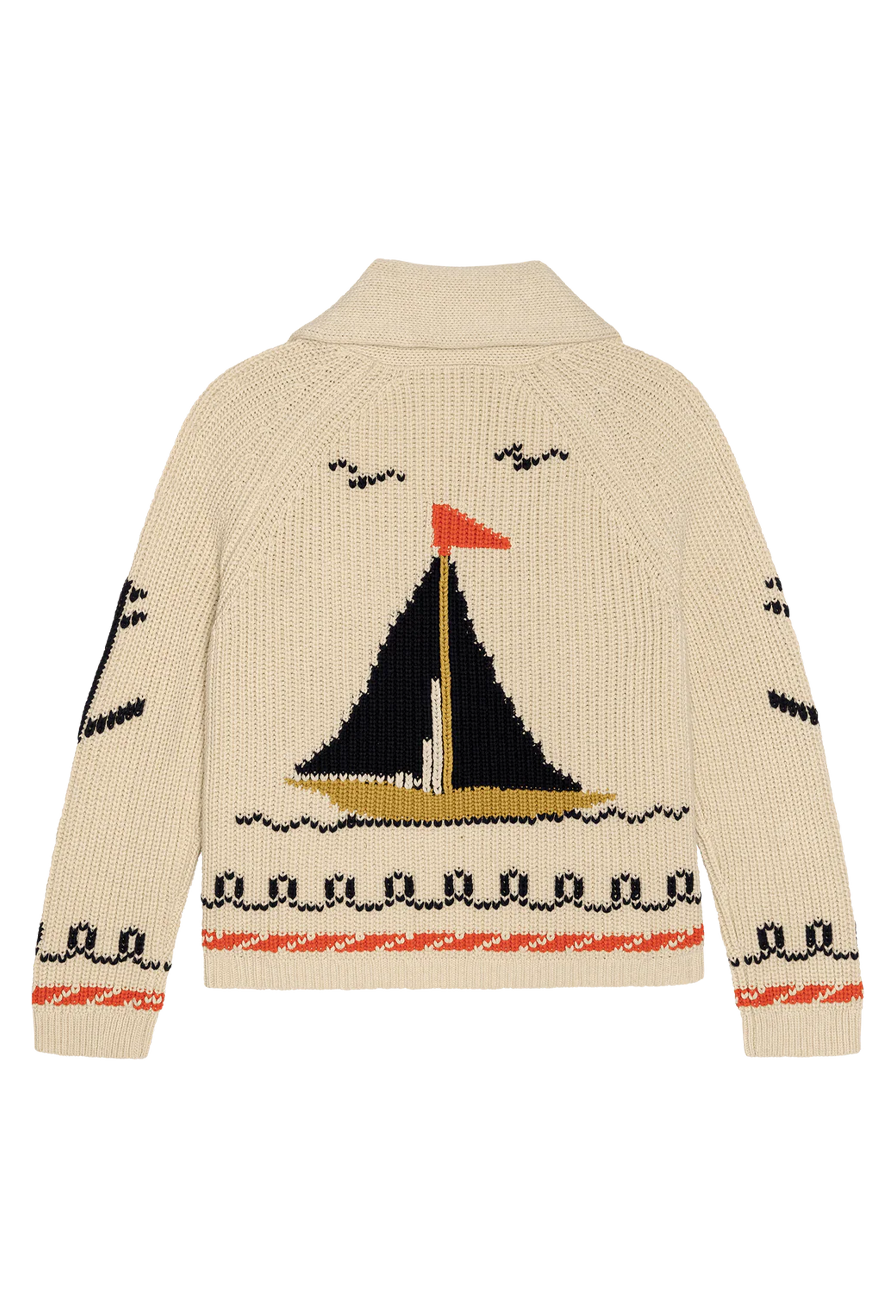 beige cardigan with embroidered sailboat motifs on a white background