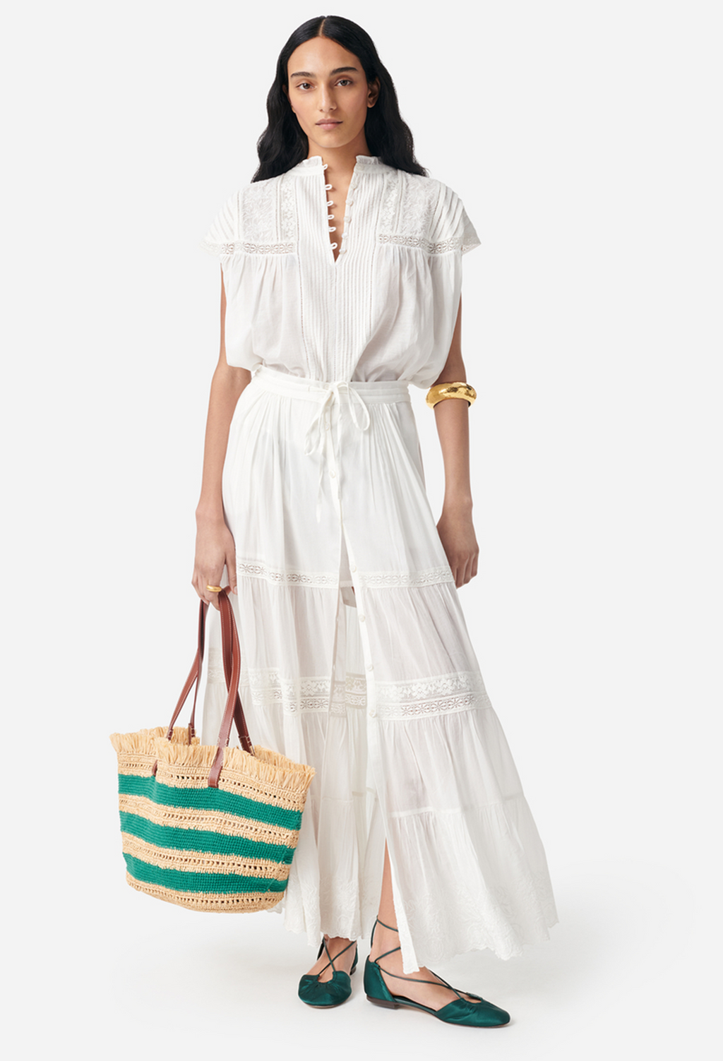model wearing a white skirt and short sleeve white blouse on a white background