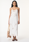 model wearing a white midi dress with thin straps on a white background