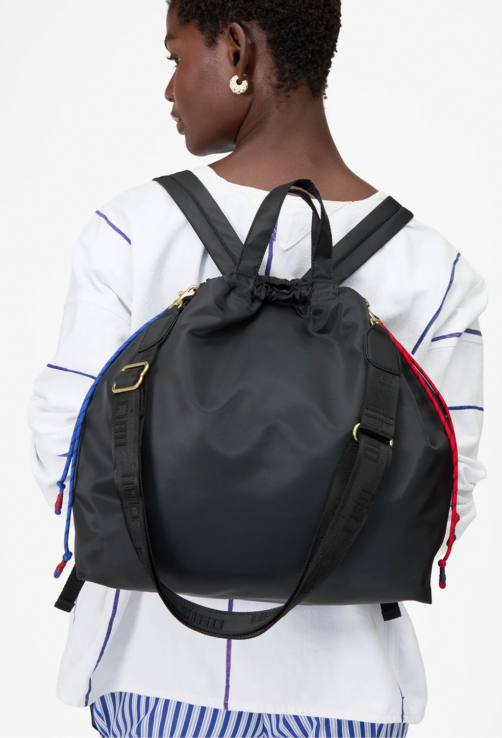 Person wearing a black backpack on a white background