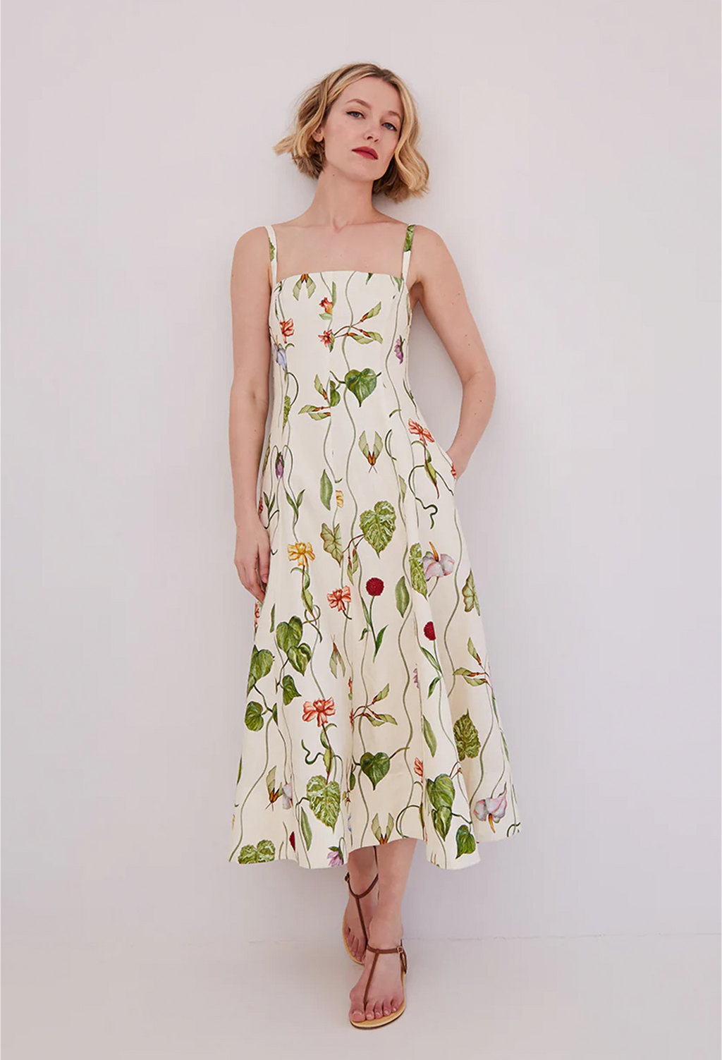 Woman wearing a floral dress against a plain background
