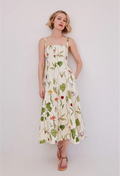 Woman wearing a floral dress against a plain background