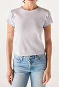 Person wearing a plain light purple t-shirt and light blue jeans on a white background