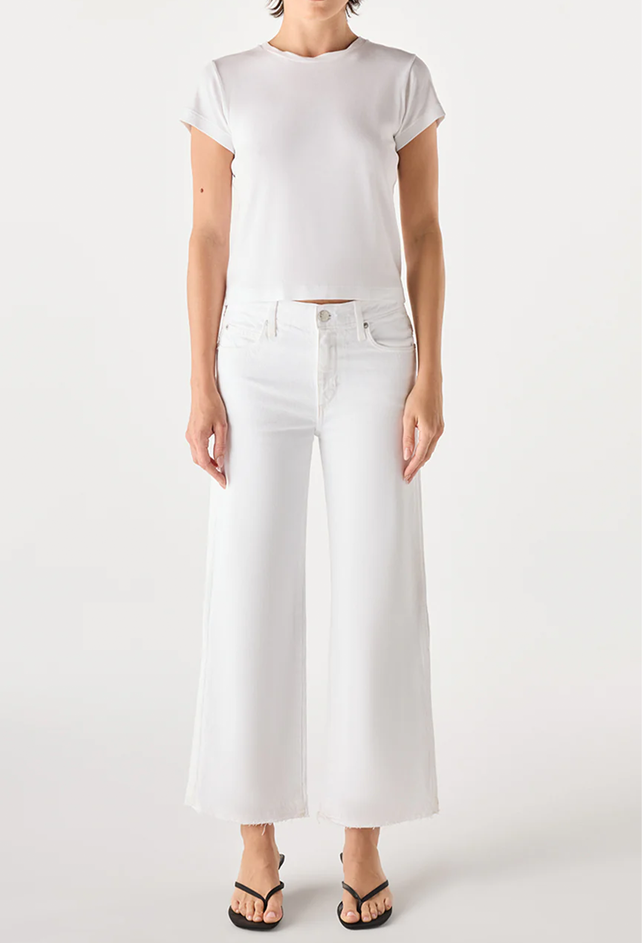 Person wearing a white t-shirt and white jeans on a white background