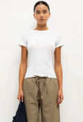 Woman wearing a white t-shirt and beige pants against a white background