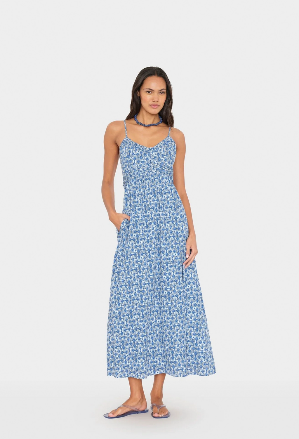 Woman wearing a blue floral dress on a white background