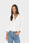 Woman wearing a white blouse and blue jeans on a white background