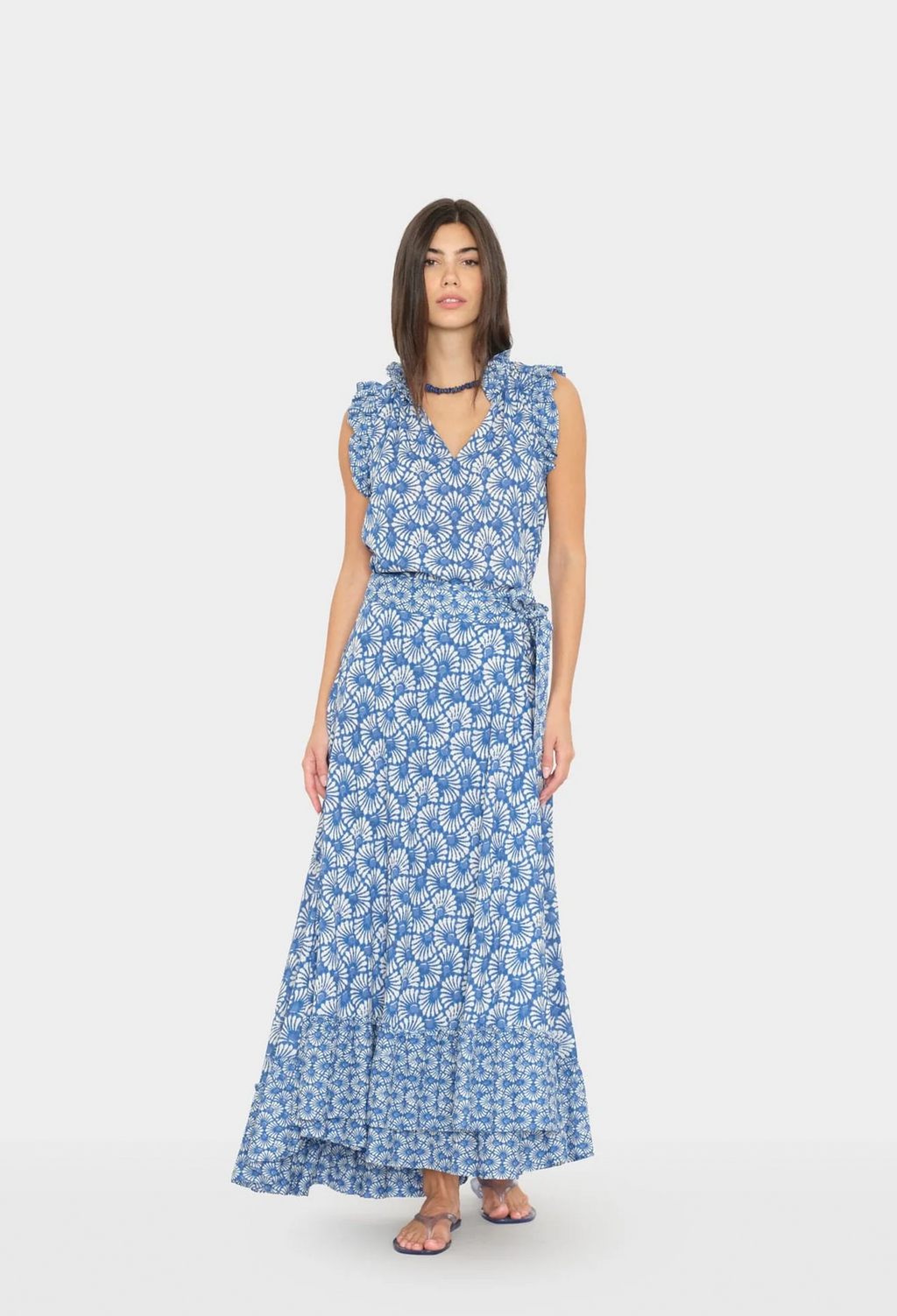 Woman wearing a blue floral dress on a white background